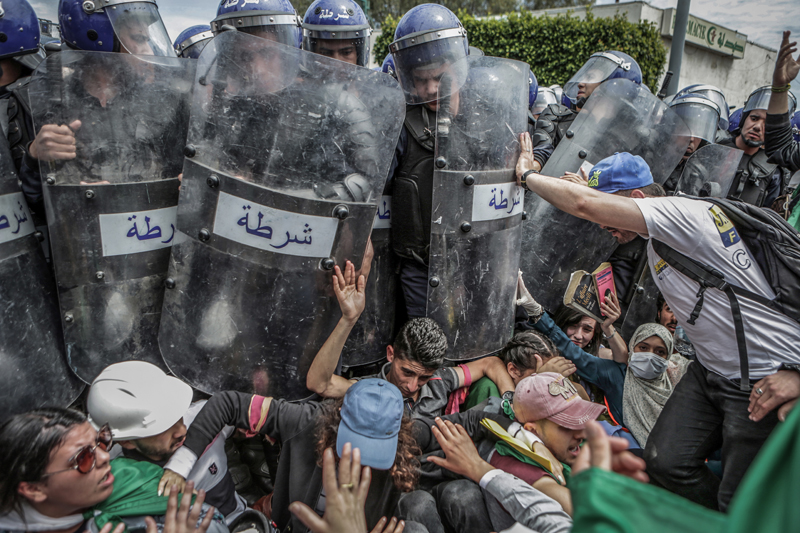 Algerian students and riot police scuffle during an anti-government demonstration. Algeria has been embroiled in an unprecedented wave of months-long protests following the February 2019 announcement of then-President Abdelaziz Bouteflika to seek a f